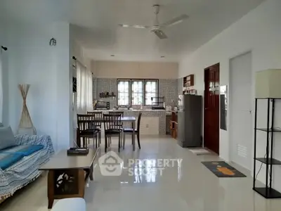 Spacious open-layout living and dining area with modern kitchen and stylish decor.
