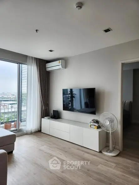 Modern living room with sleek TV setup and large window view