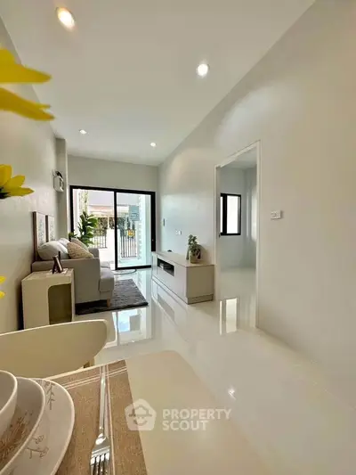 Modern living room with sleek design and natural light, featuring open layout and stylish decor.