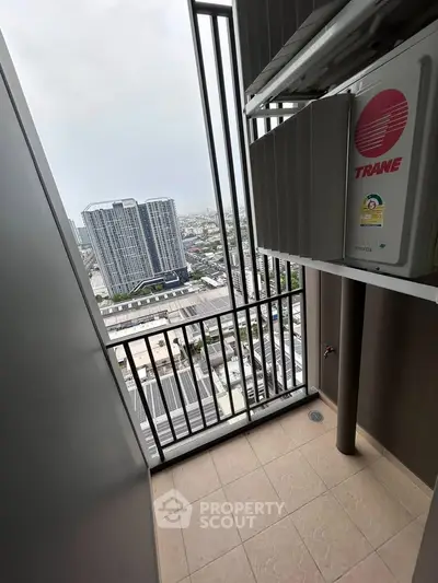 High-rise balcony with city view and air conditioning unit, perfect for urban living.