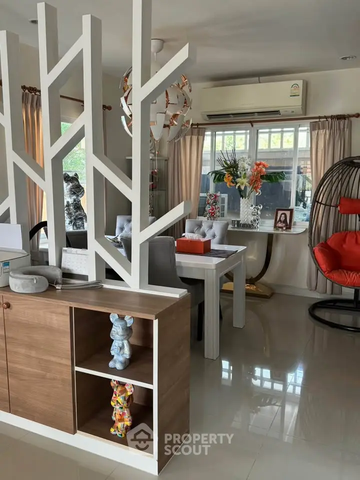 Stylish modern living room with unique decor and open layout, featuring elegant dining area and contemporary furnishings.