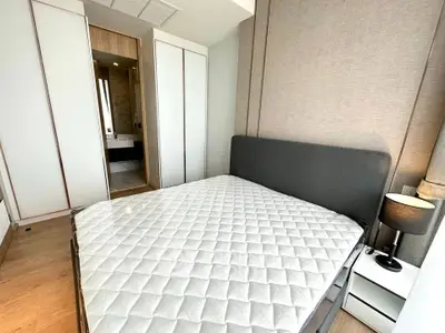 Modern bedroom with sleek design and ensuite bathroom in a stylish apartment.