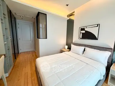 Modern bedroom with cozy bed and stylish decor in a bright apartment.