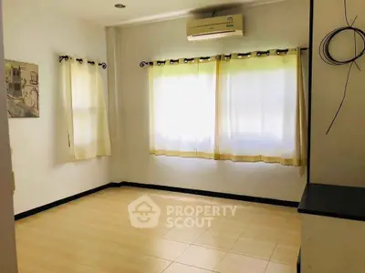 Bright empty room with air conditioning and large windows