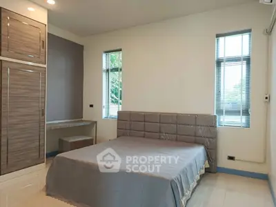 Spacious bedroom with modern furnishings and natural light