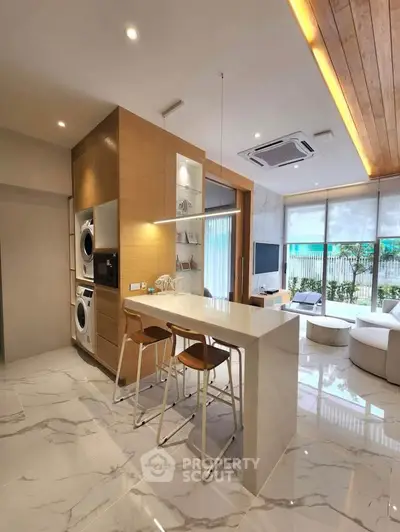 Modern open-plan living room with sleek kitchen and stylish decor