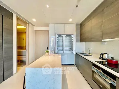 Modern kitchen with sleek design, featuring an island and high-end appliances.
