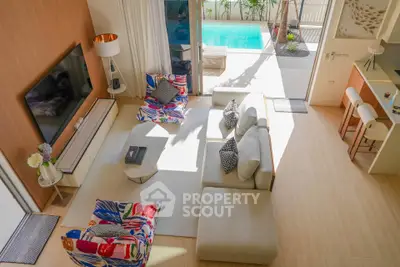 Luxurious living room with pool view, modern furniture, and open layout for ultimate comfort.