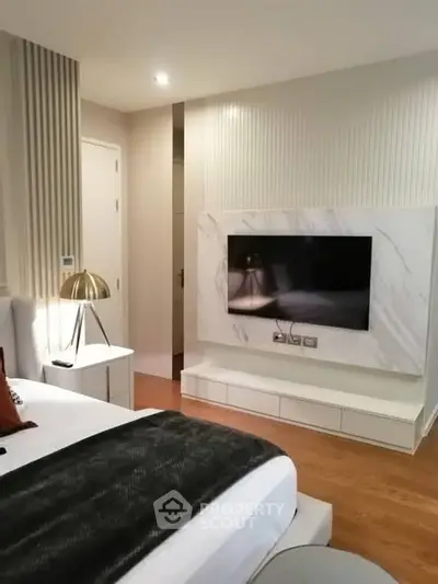 Modern bedroom with sleek TV setup and stylish decor