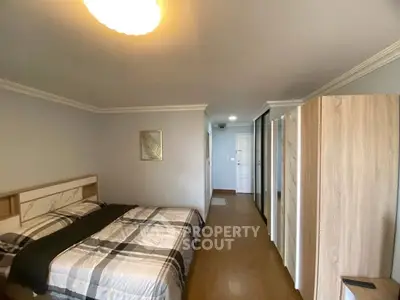 Spacious bedroom with modern decor and ample natural light