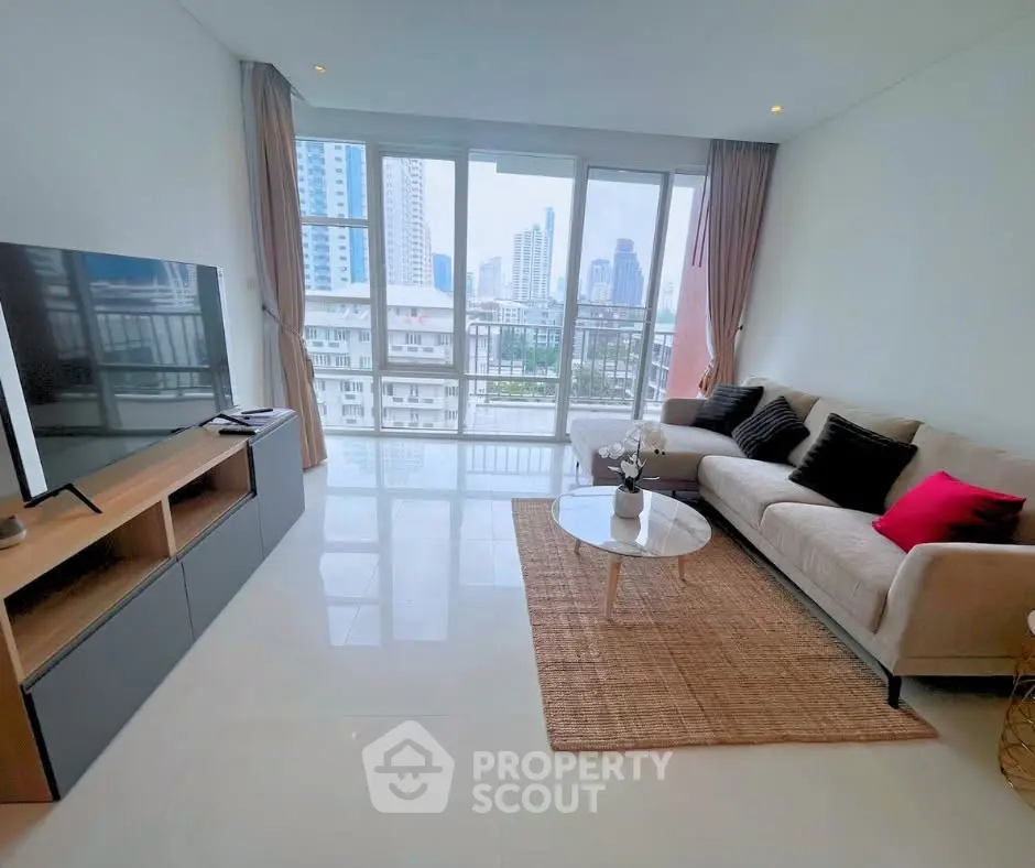 Spacious living room with city view, modern furniture, and large windows in a high-rise apartment.