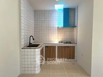 Modern kitchen with sleek design, featuring a gas stove and stylish cabinetry, perfect for culinary enthusiasts.