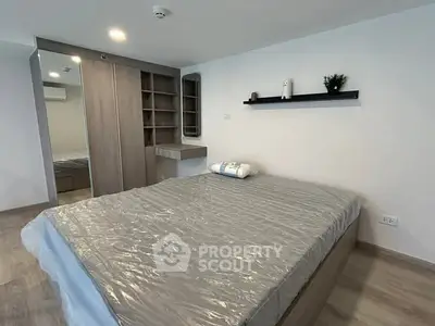 Modern bedroom with sleek design and ample storage in a stylish apartment.