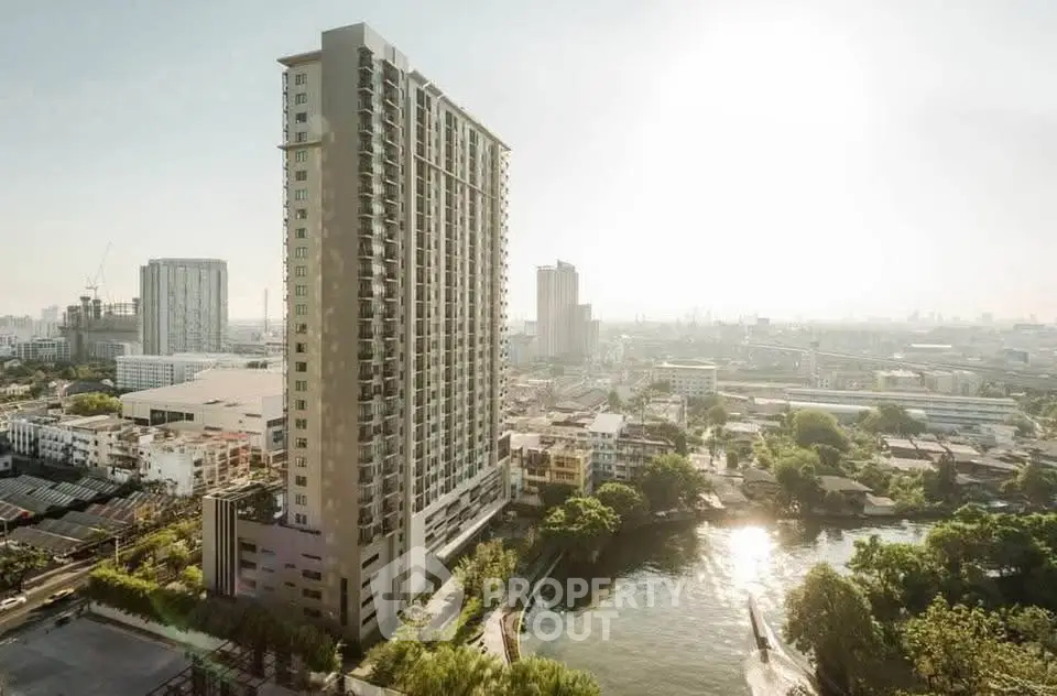 Stunning high-rise building with panoramic city views and serene riverfront location.