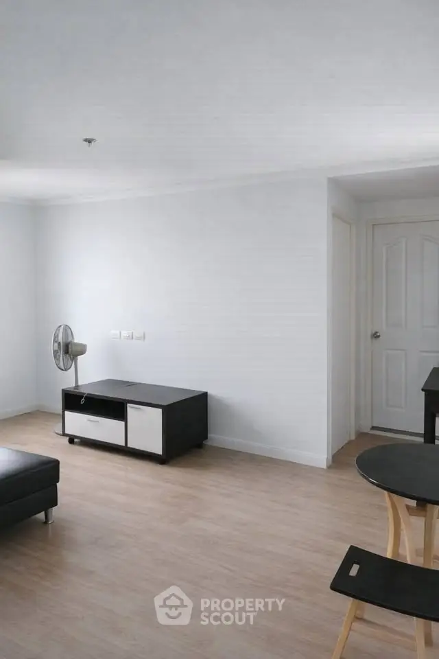 Spacious minimalist living room with modern furniture and wooden flooring