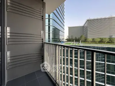 Modern balcony with sleek railing and stunning cityscape view in a high-rise building.