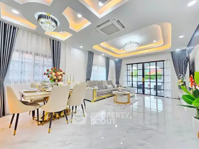 Luxurious modern living room with elegant chandeliers and spacious dining area