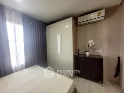 Cozy bedroom with modern wardrobe and air conditioning, perfect for comfortable living.