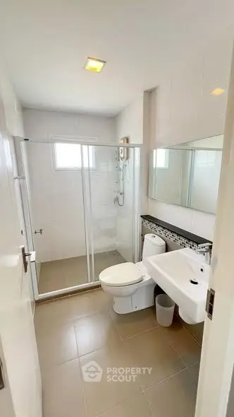 Modern bathroom with glass shower and sleek fixtures