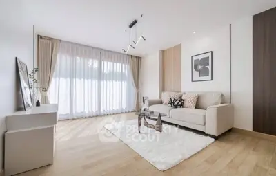 Modern living room with elegant decor and large window for natural light