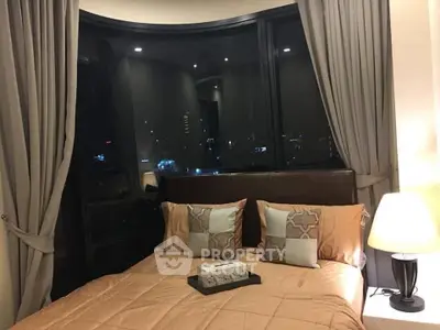 Luxurious bedroom with city view, elegant decor, and ambient lighting for a cozy urban retreat.