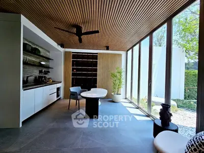 Modern living room with floor-to-ceiling windows and stylish wooden ceiling
