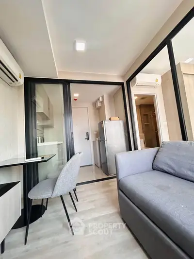 Modern apartment interior with open layout, featuring a cozy living area and sleek kitchen.