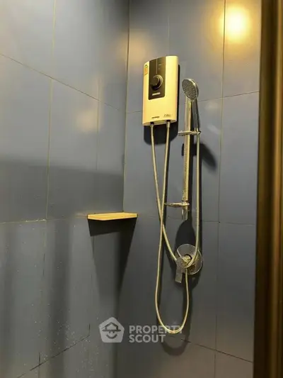 Modern bathroom shower with sleek blue tiles and water heater