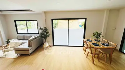 Spacious living and dining area with modern decor and natural light