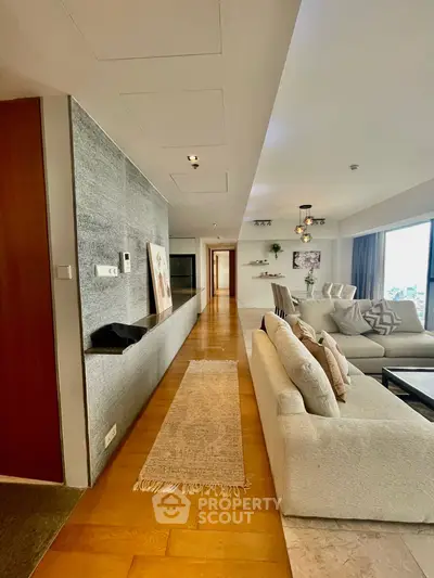 Spacious modern living room with elegant decor and city view, perfect for luxury urban living.
