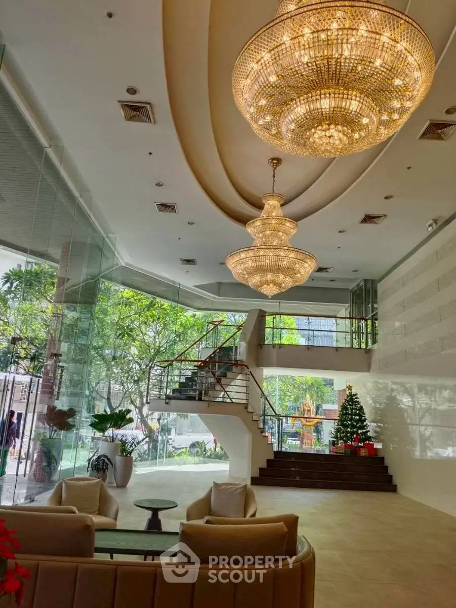 Luxurious lobby with grand chandeliers and elegant staircase in modern building