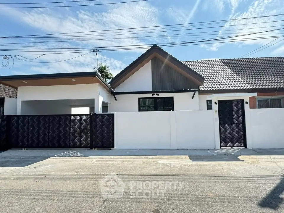 Charming single-story home with modern facade and secure gated entrance in a peaceful neighborhood.