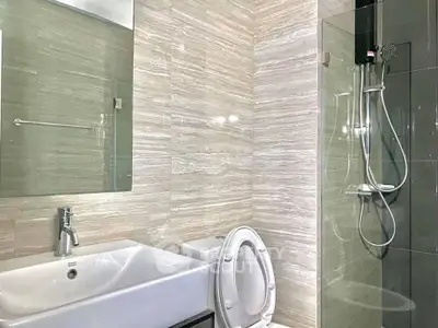 Modern bathroom with sleek fixtures and glass shower enclosure
