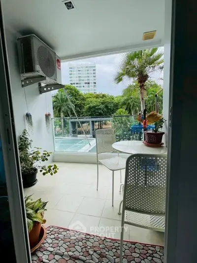 Charming balcony with lush garden view, perfect for relaxation and outdoor dining.