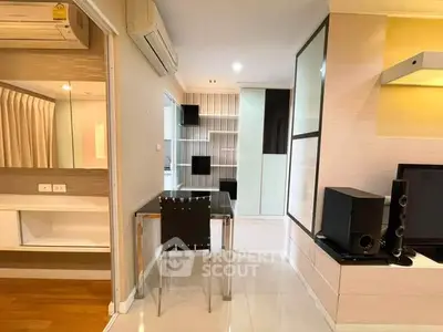 Modern apartment interior with sleek furniture and built-in storage solutions.