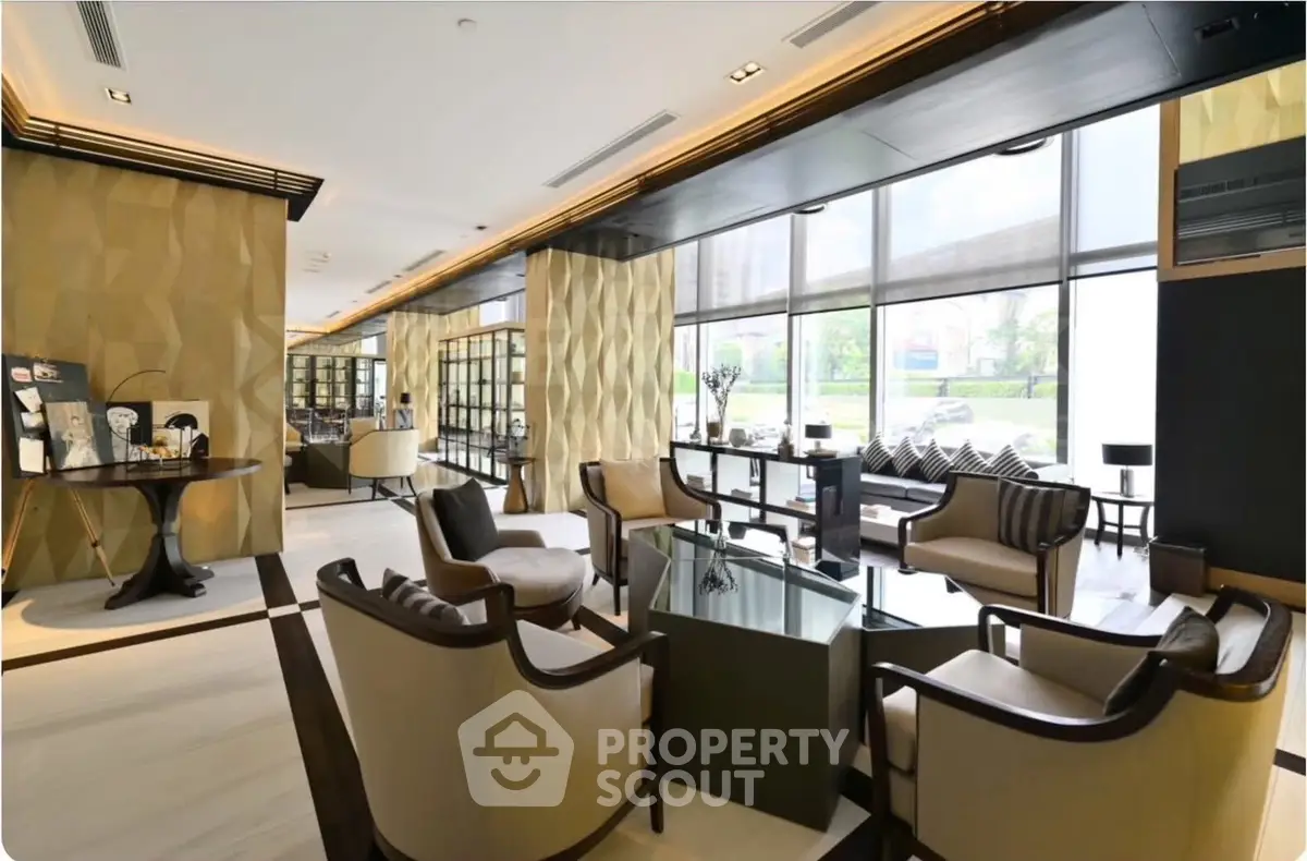 Luxurious modern living room with elegant furniture and large windows offering natural light.