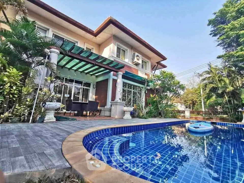 Luxurious two-story home with private pool and lush garden