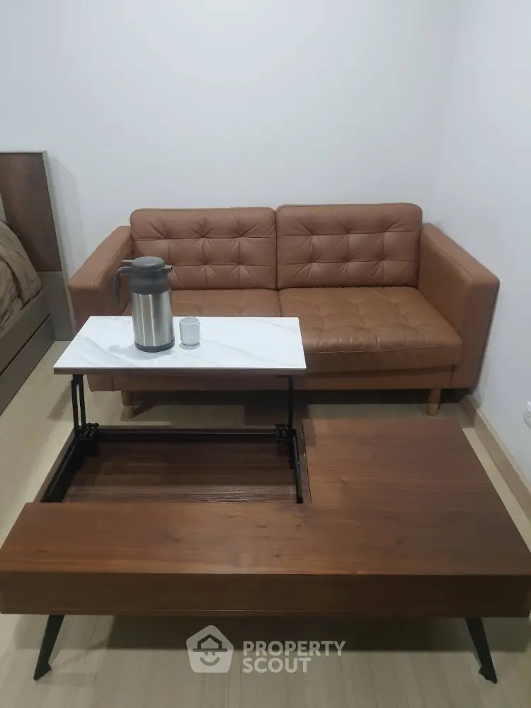 Cozy living room with stylish brown leather sofa and modern coffee table