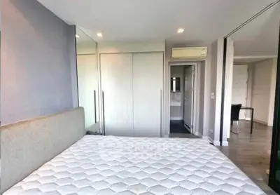 Modern bedroom with built-in wardrobe and air conditioning unit