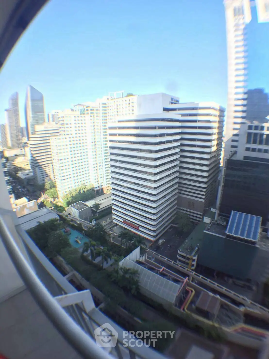 Stunning cityscape view from a high-rise balcony showcasing modern architecture and urban living.