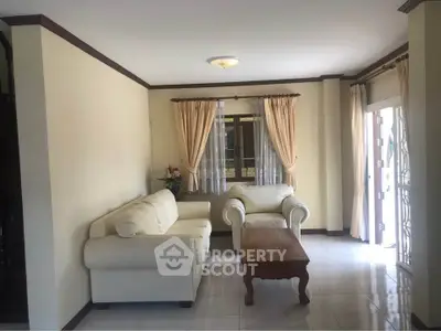 Cozy living room with cream sofas and natural light