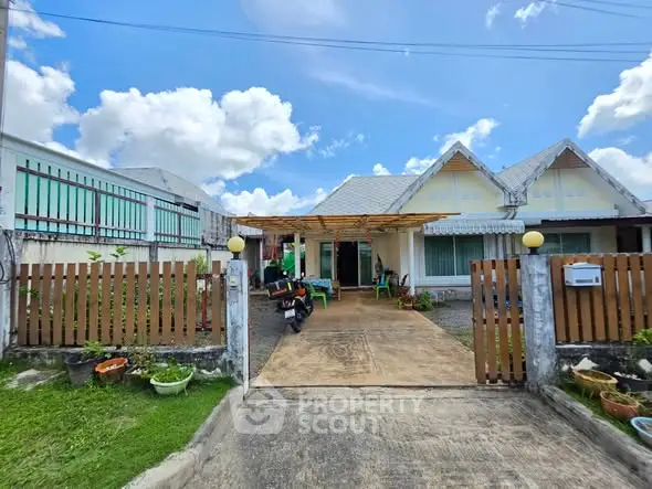 Charming suburban home with spacious driveway and lush garden, perfect for family living.