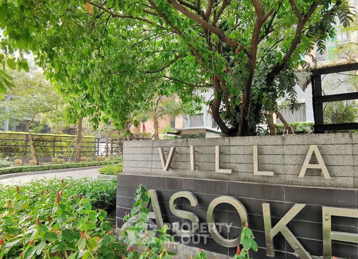 Charming entrance of Villa Asoke with lush greenery and modern design.