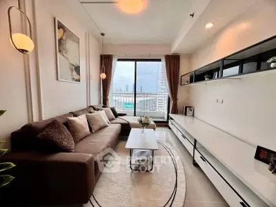 Modern living room with large window and stylish decor in urban apartment.