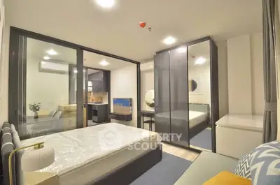 Modern bedroom with glass partition and stylish decor in a contemporary apartment.