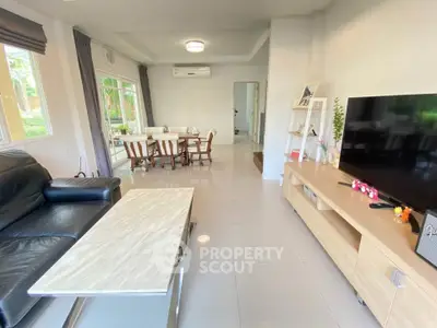 Spacious living room with modern furniture and large windows for natural light