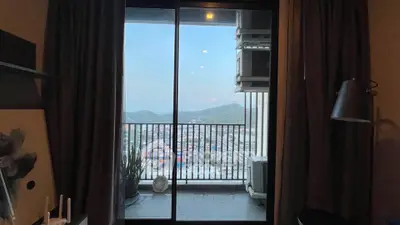 Stunning balcony view with mountains and cityscape, perfect for relaxation and enjoying sunsets.