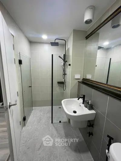 Modern bathroom with sleek fixtures and glass shower enclosure