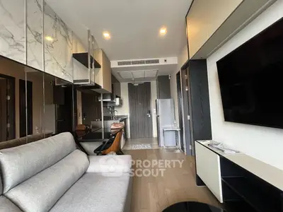 Modern living room with sleek kitchen and stylish decor in a contemporary apartment.