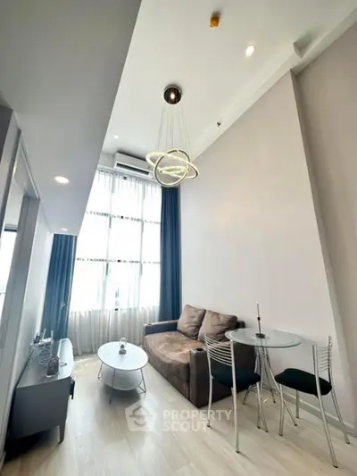 Modern living room with high ceiling and stylish lighting in a contemporary apartment
